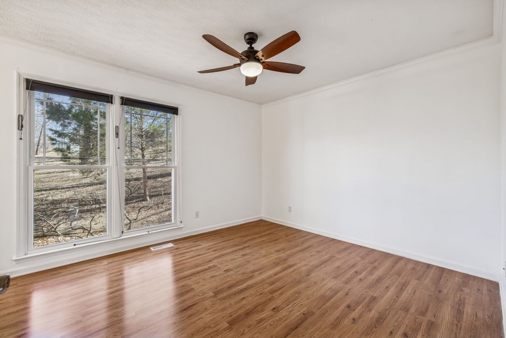 1728 Riverhaven Drive Adams, TN 37010 - Photo 35 of 75 an empty room with wooden floor fan and windows