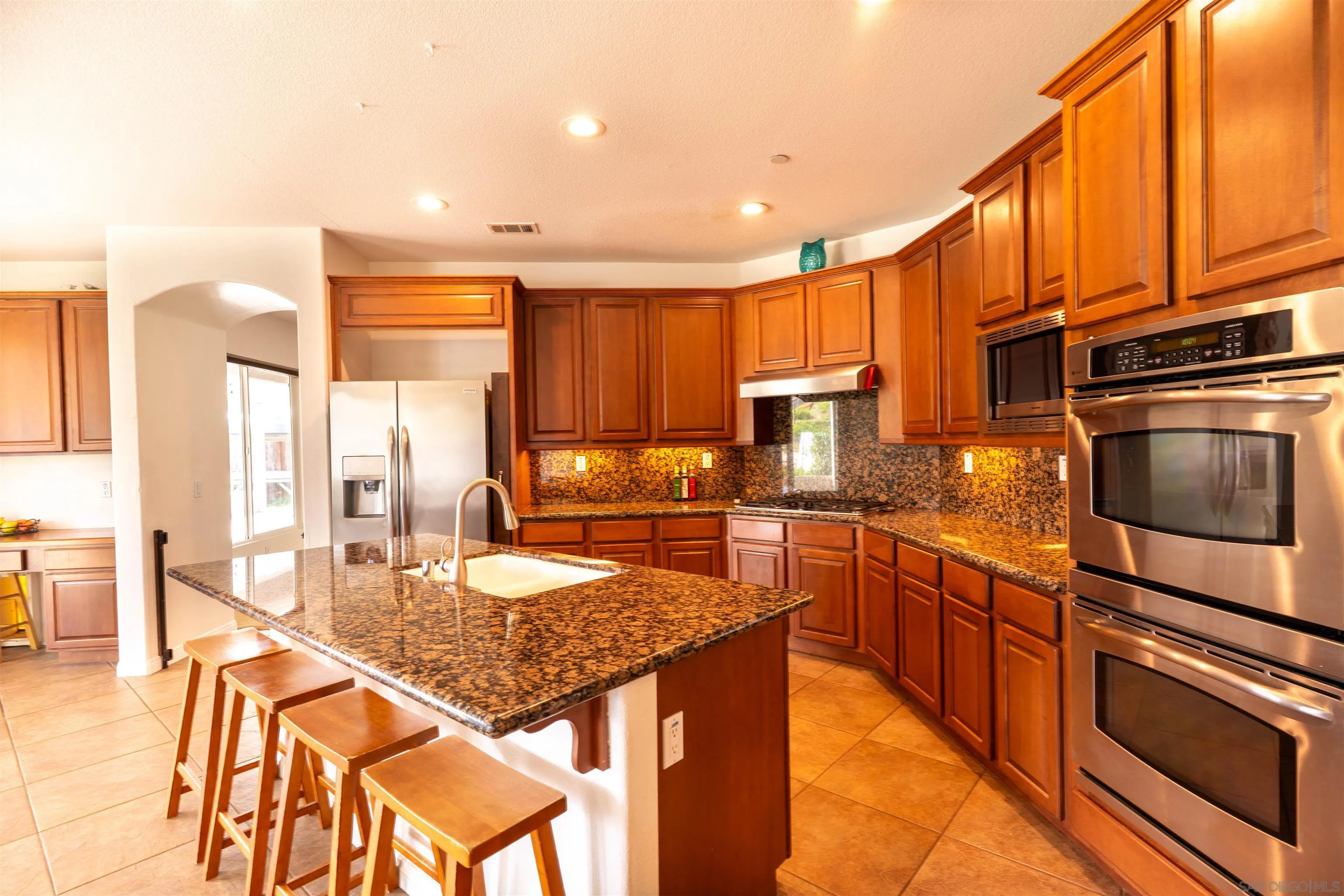 2352 Clearcrest Lane Fallbrook, CA 92028 - Photo 8 of 33 a kitchen with stainless steel appliances granite countertop a stove a sink and a microwave