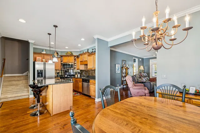 a kitchen with stainless steel appliances granite countertop a refrigerator and a sink