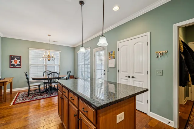 a view of a room with wooden floor and windows