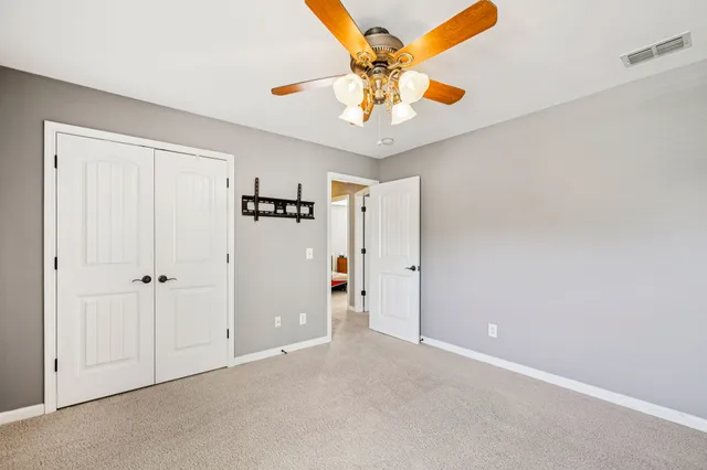 a backyard of a house with barbeque oven table and chairs