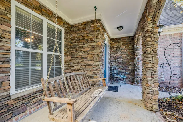 a bed room with furniture and a flat screen tv
