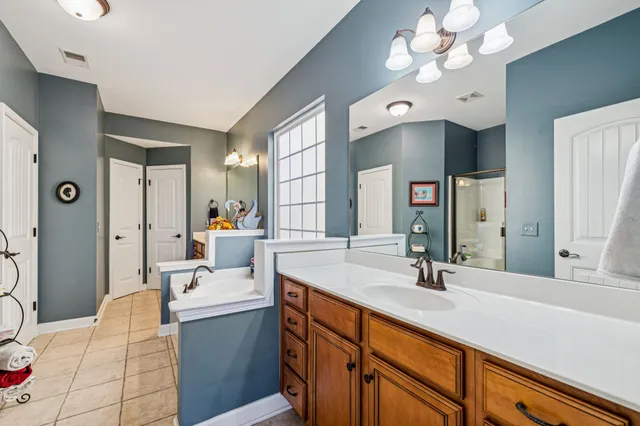 a view of walk in closet with clothes