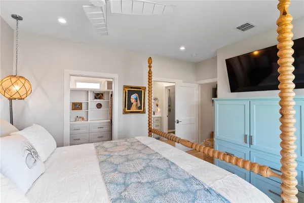 a bedroom with furniture and a chandelier