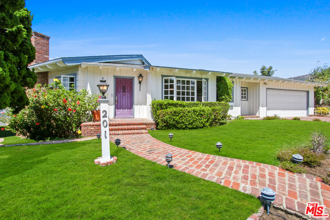 201 Tranquillo Road Pacific Palisades, CA 90272 - Photo 2 of 19 a front view of a house with a yard