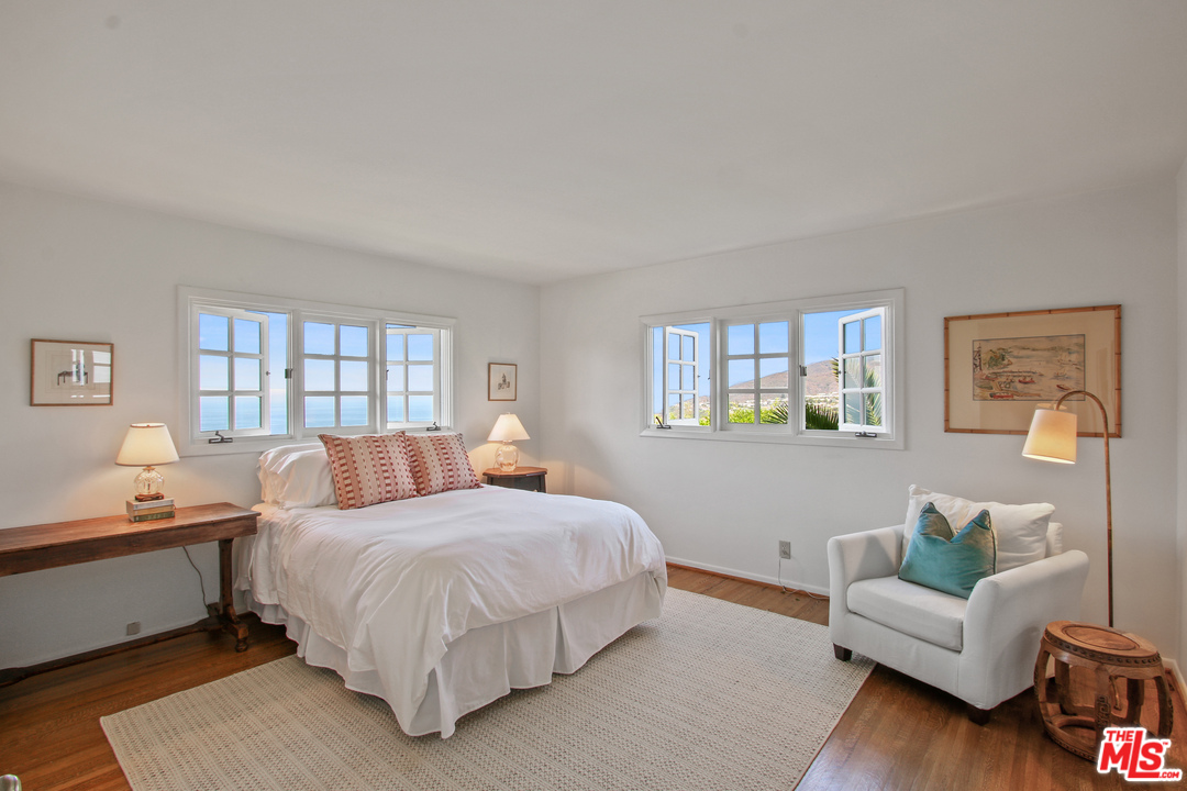 201 Tranquillo Road Pacific Palisades, CA 90272 - Photo 11 of 19 a bedroom with a bed and a couch with window