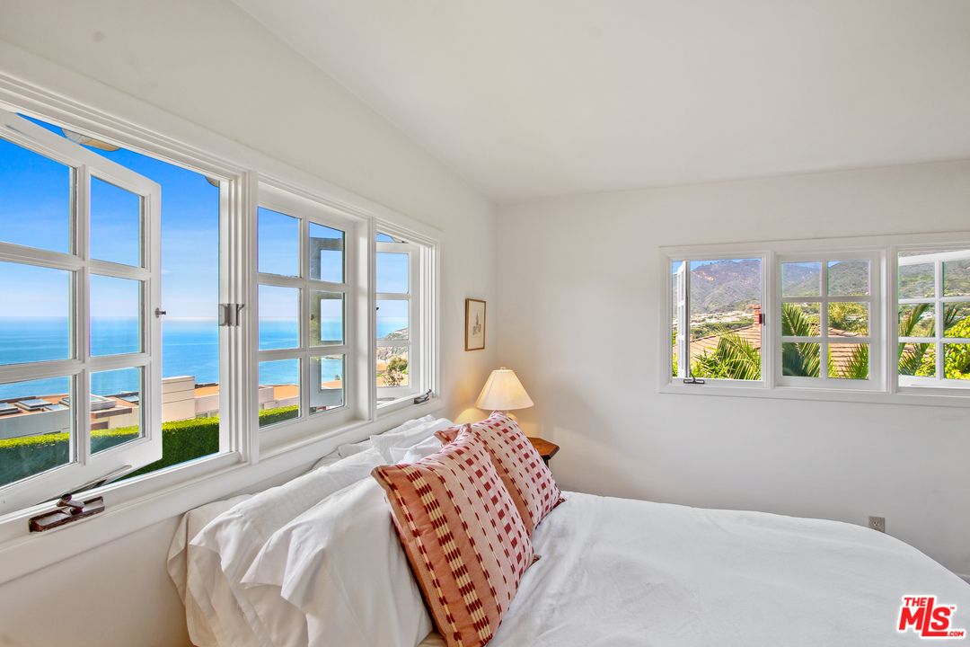 201 Tranquillo Road Pacific Palisades, CA 90272 - Photo 12 of 19 a bedroom with a bed and a large window