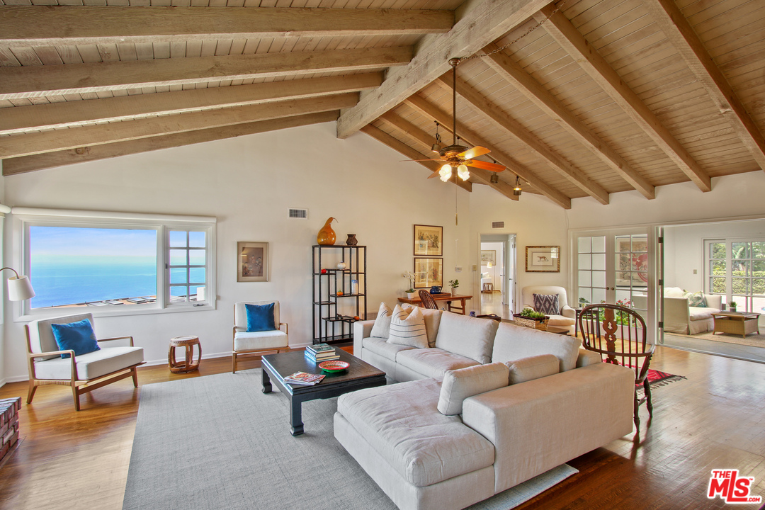 201 Tranquillo Road Pacific Palisades, CA 90272 - Photo 3 of 19 a living room with furniture and a chandelier