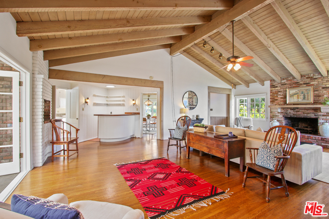 201 Tranquillo Road Pacific Palisades, CA 90272 - Photo 5 of 19 a living room with furniture and a fireplace