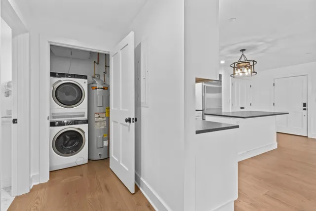 a bathroom with a granite countertop sink a toilet and shower