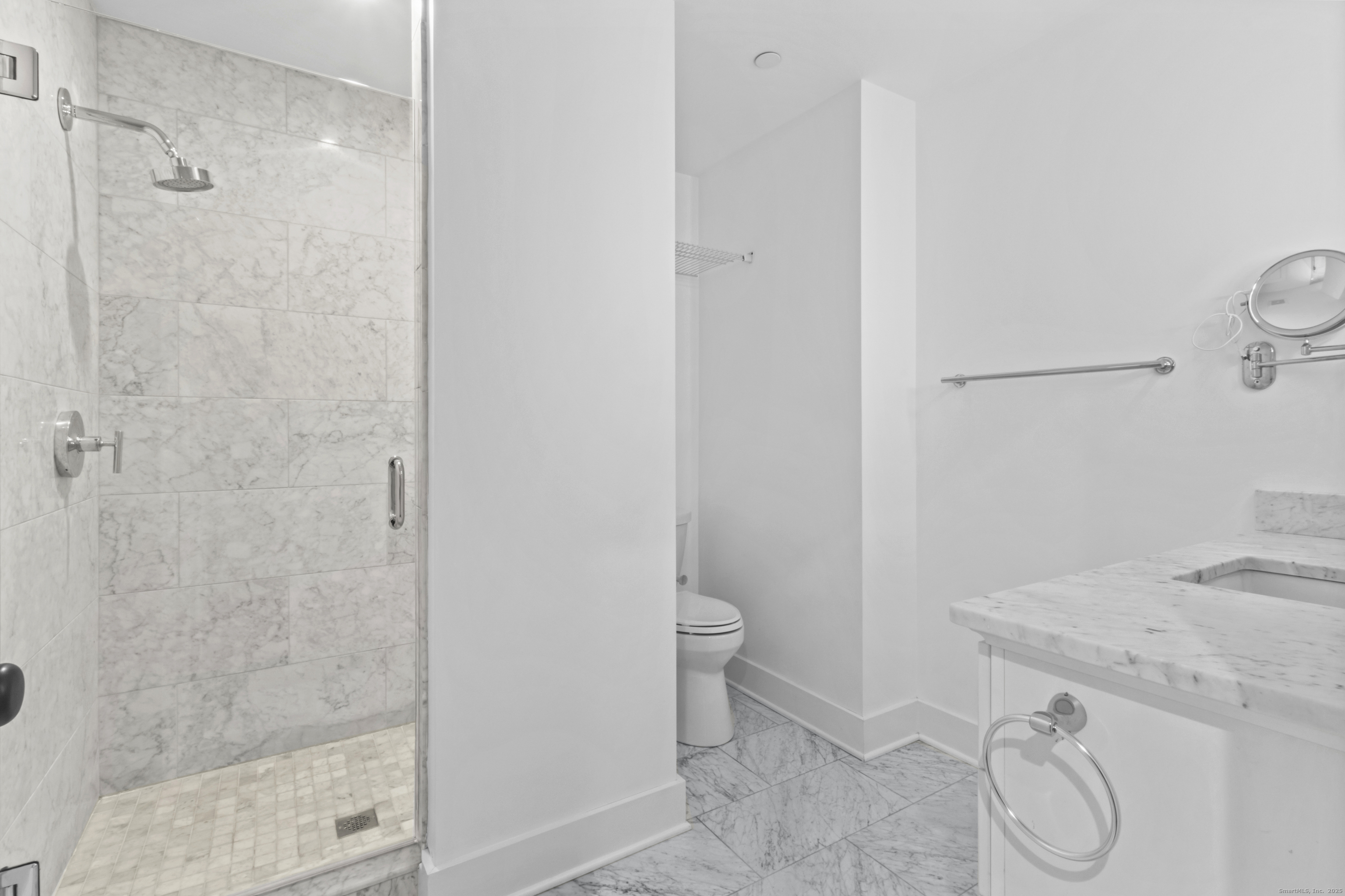 3 Water Street, Unit 305 Groton, CT 06355 - Photo 13 of 20 a bathroom with a granite countertop sink a toilet and shower