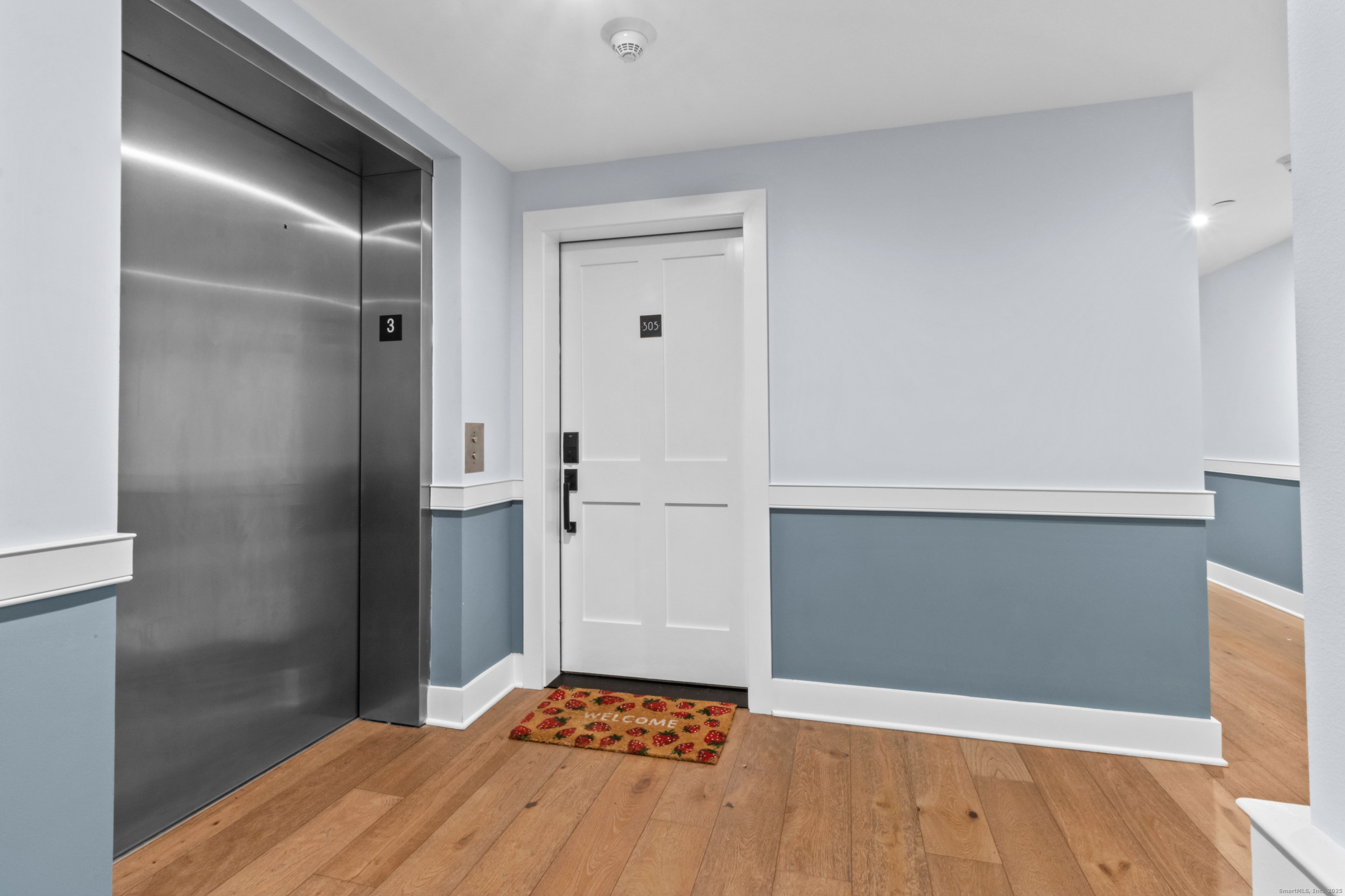 3 Water Street, Unit 305 Groton, CT 06355 - Photo 16 of 20 a bedroom with a bed and wooden floor