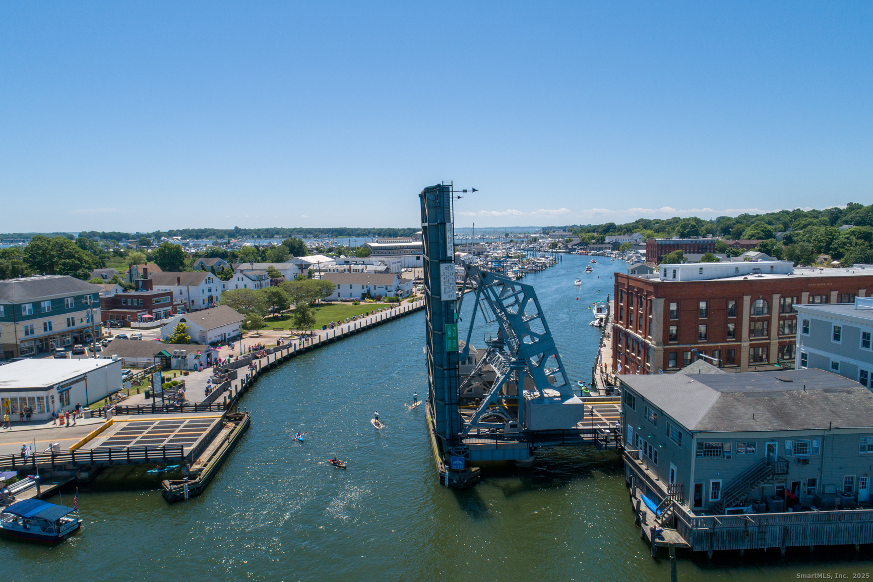 3 Water Street, Unit 305 Groton, CT 06355 - Photo 19 of 20 a view of a chairs and table in patio with a lake view