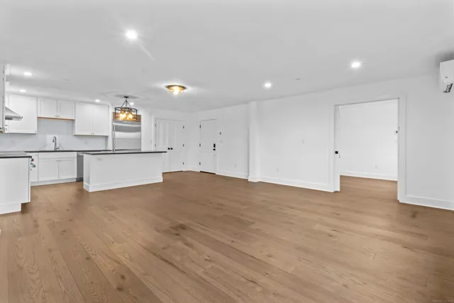 a view of a kitchen with white cabinets