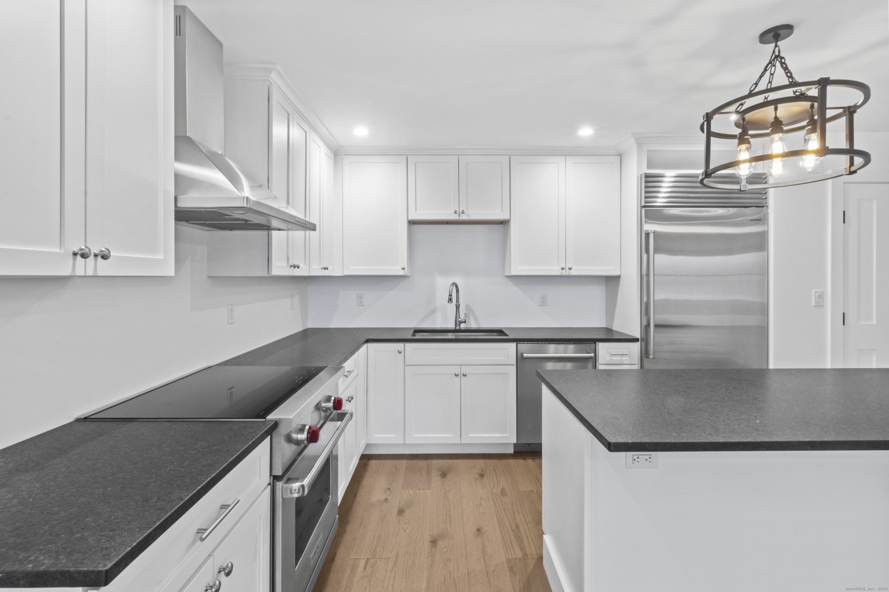 3 Water Street, Unit 305 Groton, CT 06355 - Photo 6 of 20 a kitchen with stainless steel appliances granite countertop a sink a stove and a refrigerator