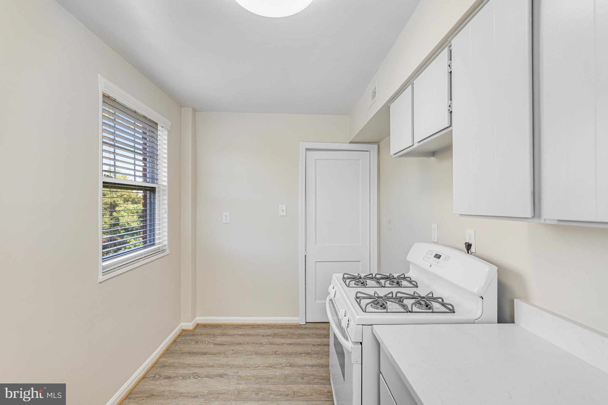 1404 12th Street North, Unit 32 Arlington, VA 22209 - Photo 14 of 26 a kitchen with a stove and a microwave
