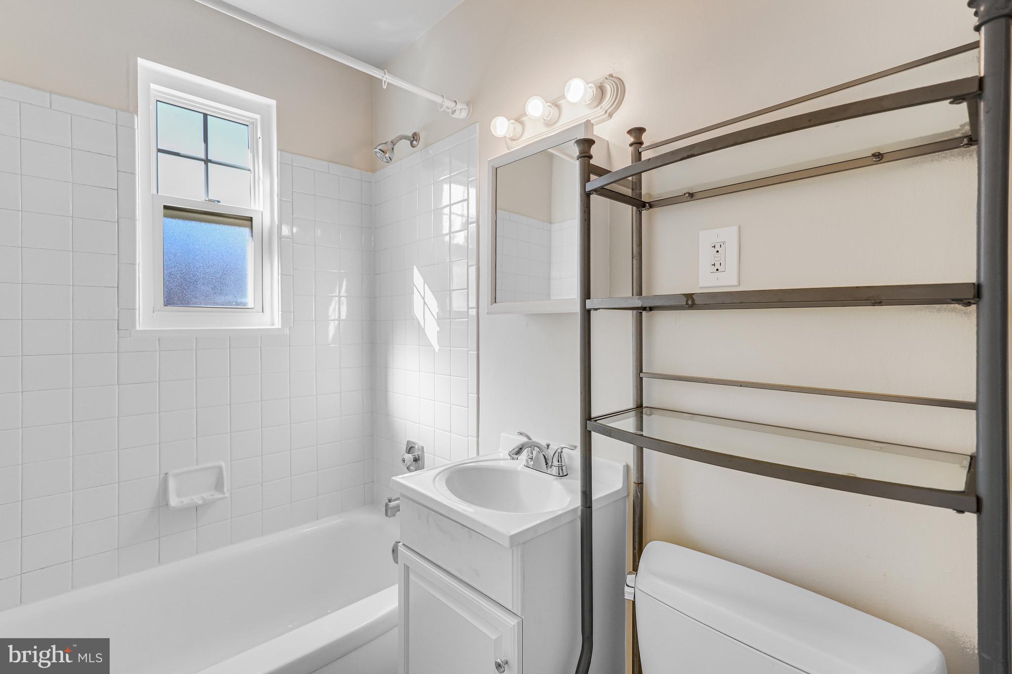 1404 12th Street North, Unit 32 Arlington, VA 22209 - Photo 18 of 26 a bathroom with a shower a toilet and sink