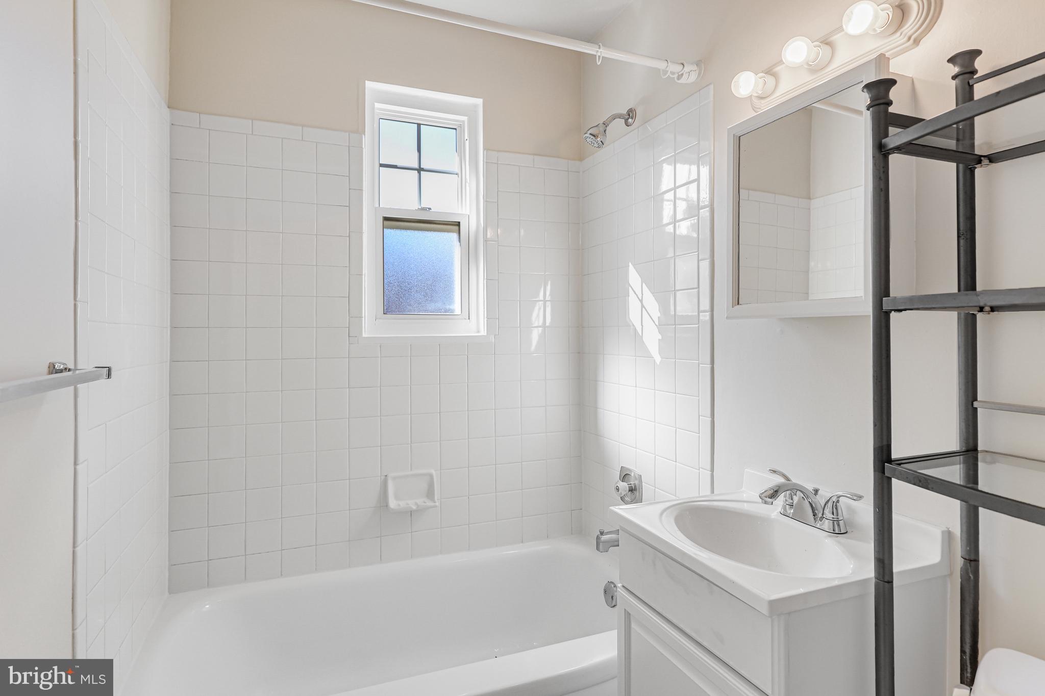 1404 12th Street North, Unit 32 Arlington, VA 22209 - Photo 19 of 26 a bathroom with a tub sink and mirror