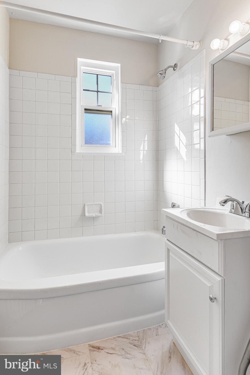 1404 12th Street North, Unit 32 Arlington, VA 22209 - Photo 20 of 26 a bathroom with a bathtub and a sink