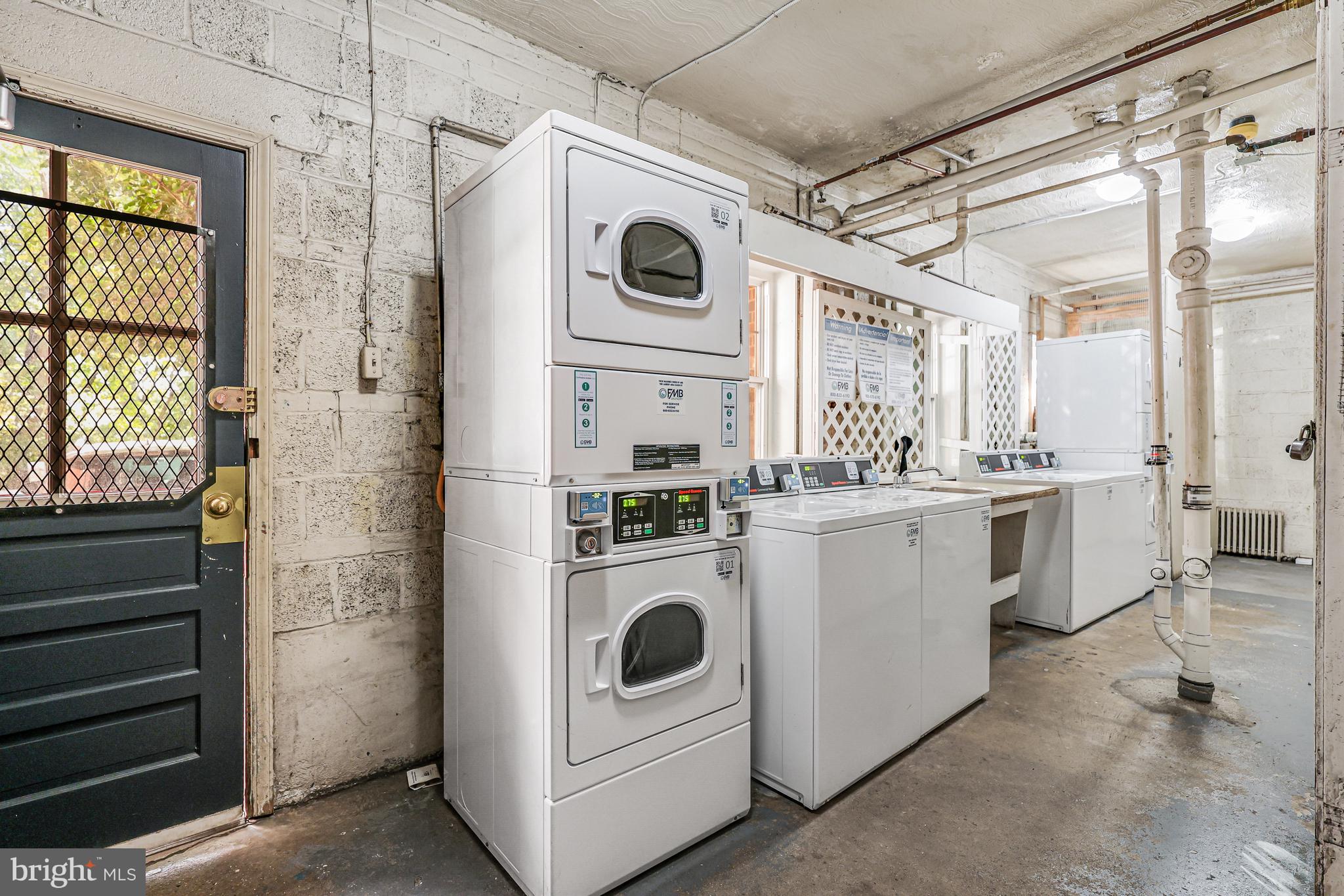 1404 12th Street North, Unit 32 Arlington, VA 22209 - Photo 22 of 26 a kitchen with white cabinets and white appliances