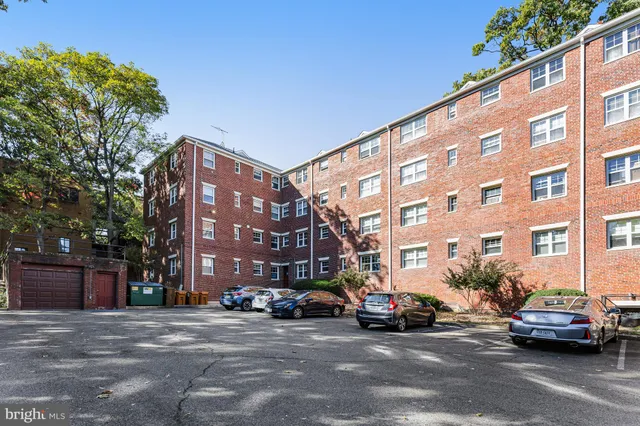 front view of a brick house with a large windows and a yard