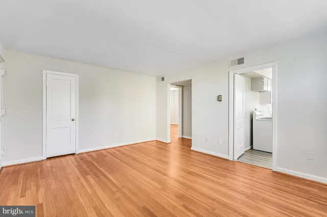 a kitchen with stainless steel appliances granite countertop a stove a sink dishwasher a dining table and chairs with wooden floor