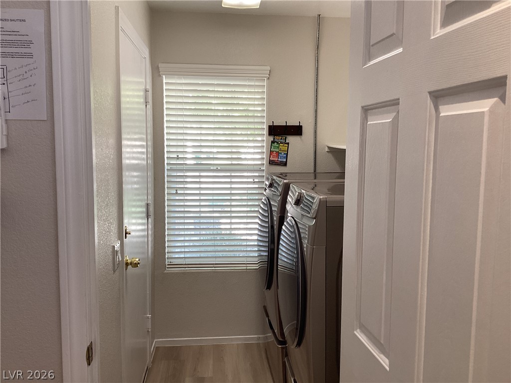 2135 Hidden Ranch Terrace Henderson, NV 89052 - Photo 8 of 27 Functional laundry space with sleek appliances and practical shelving for organization.