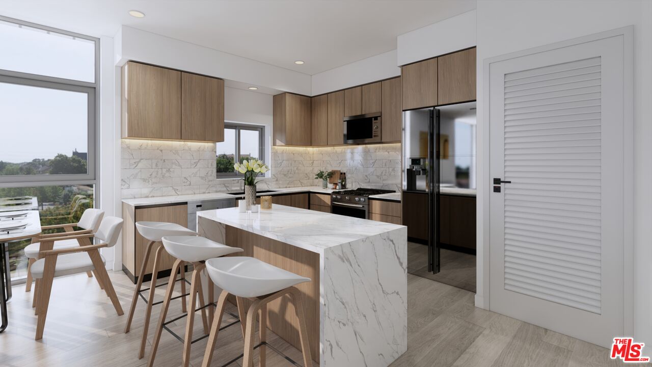 160 Chestnut Street, Unit 204 Pasadena, CA 91103 - Photo 1 of 22 a kitchen with stainless steel appliances kitchen island granite countertop a refrigerator a stove a sink and white cabinets with wooden floor
