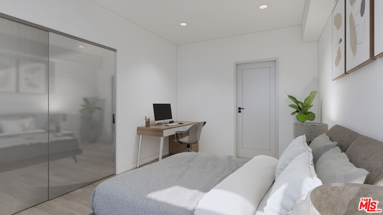 160 Chestnut Street, Unit 204 Pasadena, CA 91103 - Photo 11 of 22 a bedroom with a bed and a table