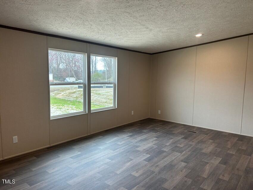 3356 North McCullen Road Faison, NC 28341 - Photo 13 of 25 an empty room with wooden floor and windows