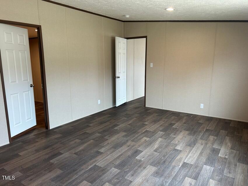 3356 North McCullen Road Faison, NC 28341 - Photo 14 of 25 a view of an empty room with wooden floor and closet