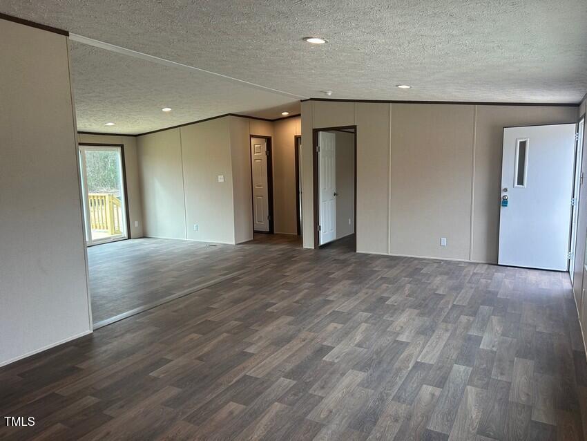 3356 North McCullen Road Faison, NC 28341 - Photo 6 of 25 an empty room with wooden floor and windows