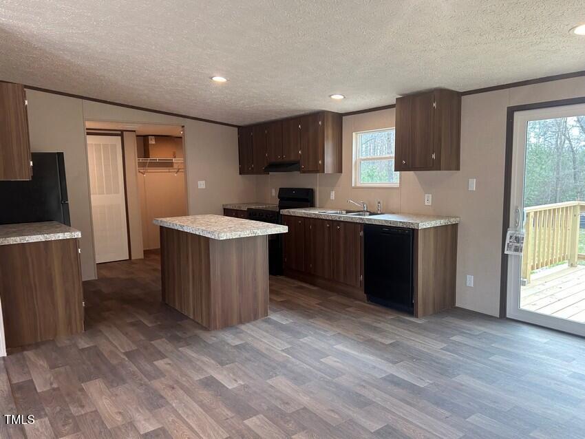 3356 North McCullen Road Faison, NC 28341 - Photo 7 of 25 a kitchen with stainless steel appliances granite countertop a sink and a stove