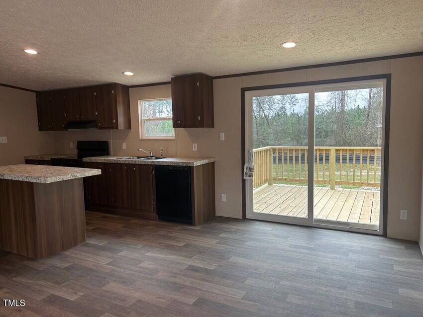 3356 North McCullen Road Faison, NC 28341 - Photo 8 of 25 a kitchen with stainless steel appliances granite countertop a stove a sink and a microwave