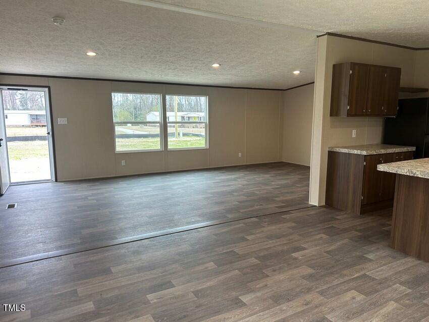 3356 North McCullen Road Faison, NC 28341 - Photo 9 of 25 an empty room with wooden floor and windows