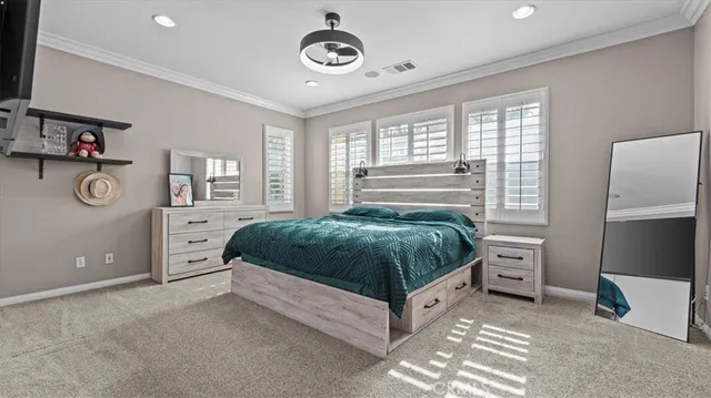 a bedroom with a bed and a chair