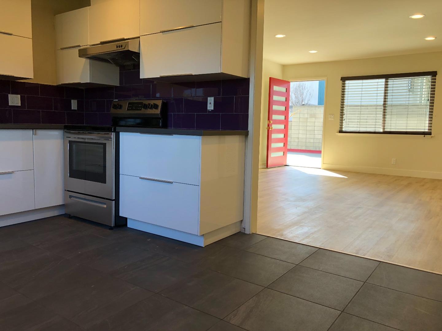 2062 Main Street Santa Clara, CA 95050 - Photo 8 of 18 a kitchen with stainless steel appliances granite countertop a stove and a refrigerator
