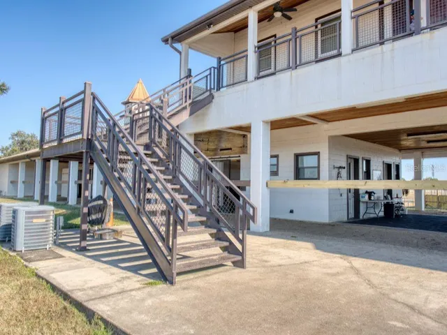 a bathroom with a granite countertop sink a toilet and a mirror