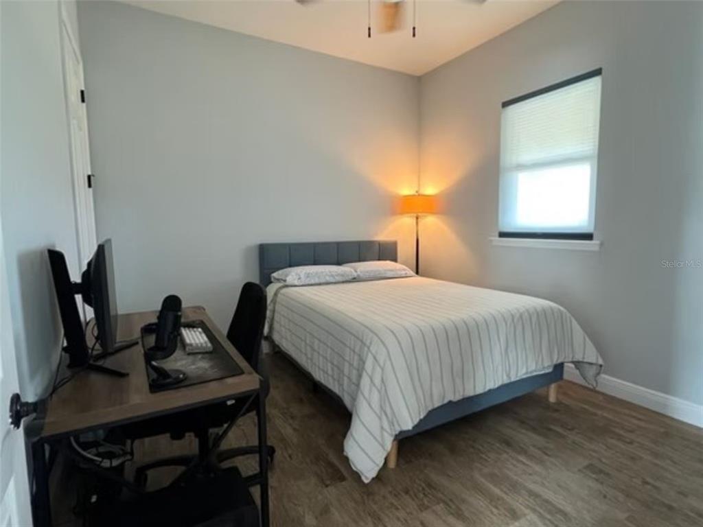 1345 Northeast 155th Place Citra, FL 32113 - Photo 22 of 82 a bedroom with a bed a desk and chair