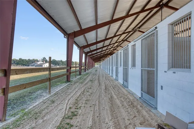 a living room with furniture floor to ceiling window and flat screen tv