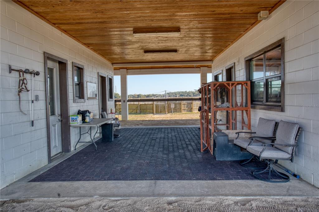 1345 Northeast 155th Place Citra, FL 32113 - Photo 38 of 82 a living room with furniture floor to ceiling window and flat screen tv