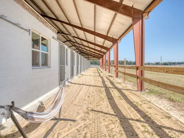 a view of an house with backyard and a garden