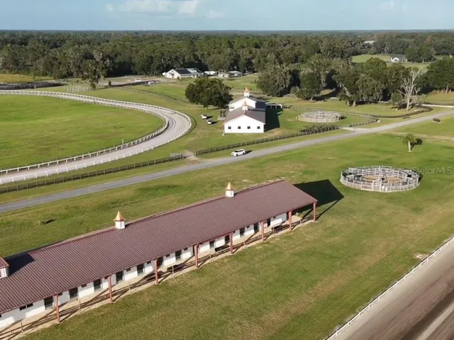 a view of a big room with gym equipment and a table