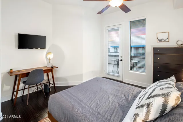 a bedroom with a bed and a chair