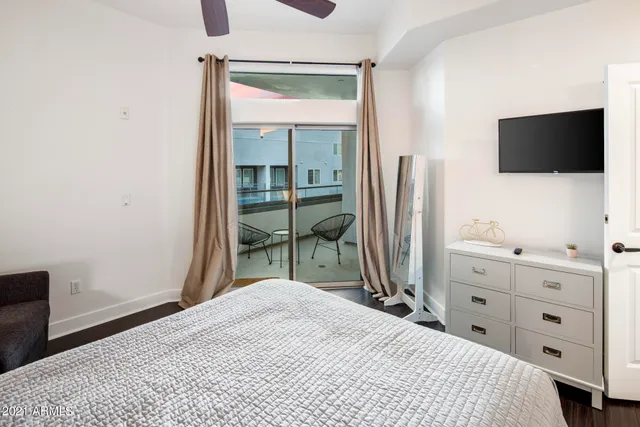 a bedroom with a bed and a flat screen tv