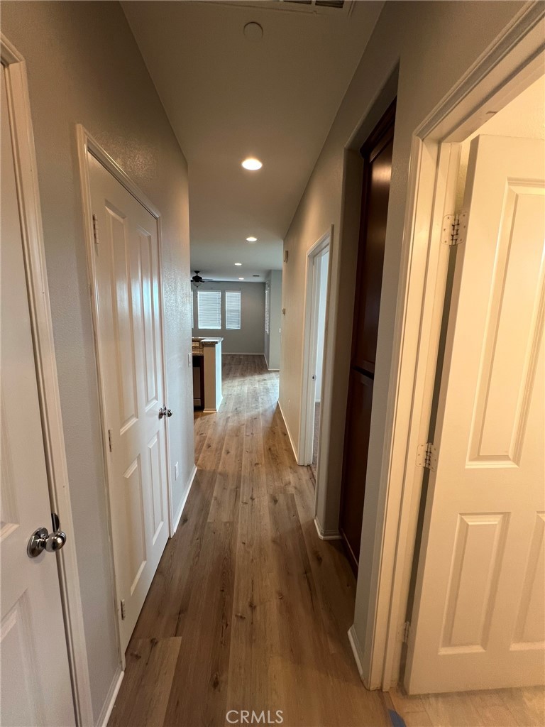 16001 Chase Fontana, CA 92336 - Photo 11 of 14 a view of a hallway with wooden floor and staircase