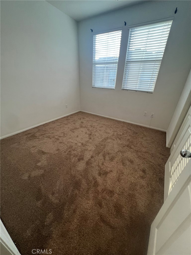 16001 Chase Fontana, CA 92336 - Photo 6 of 14 an empty room with windows