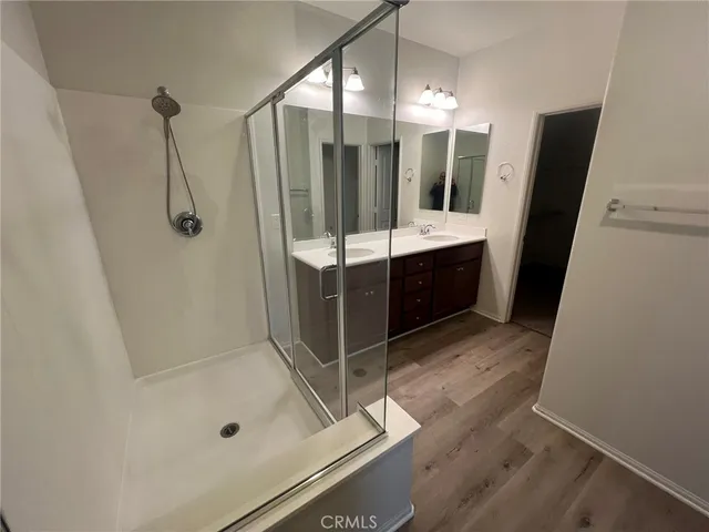 a bathroom with a sink a mirror and a shower