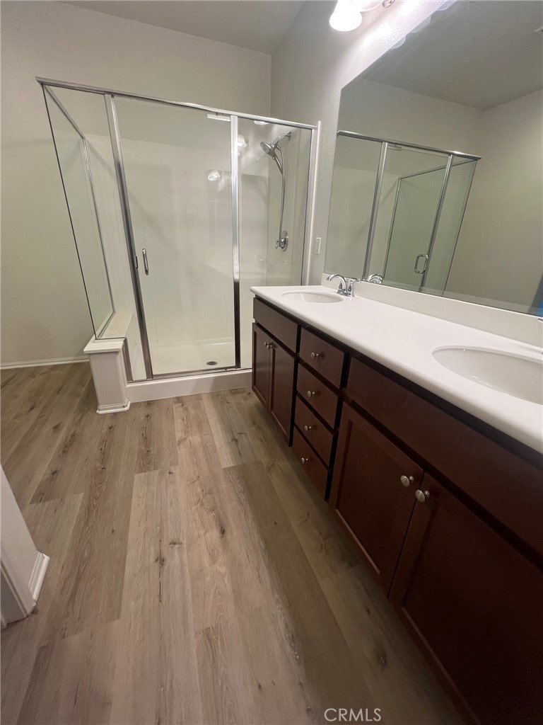 16001 Chase Fontana, CA 92336 - Photo 10 of 14 a bathroom with a sink a mirror and a shower