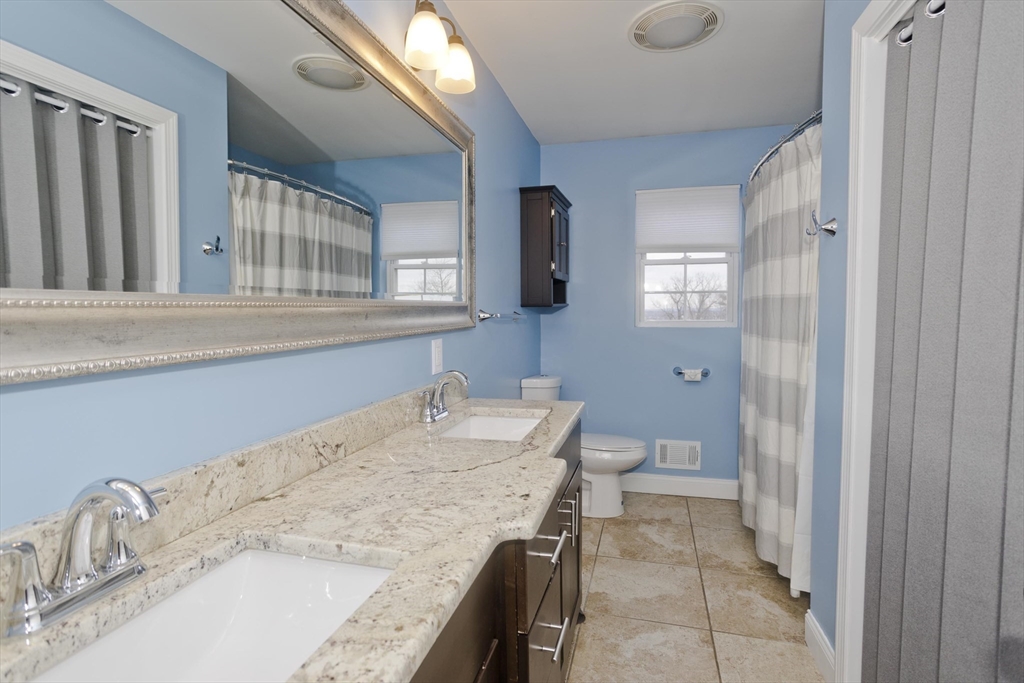48 Mountain Avenue West Springfield, MA 01089 - Photo 25 of 39 a bathroom with a granite countertop sink a toilet and a tub